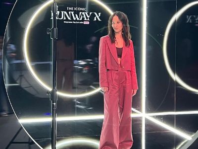 Erana James is wearing a pink jacket and a pink baggy pants. 